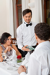 Image showing young smiling couple at the restaurant 