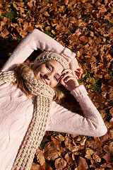 Image showing young smiling woman with hat and scarf outdoor in autumn