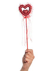 Image showing Hand with heart on a stick