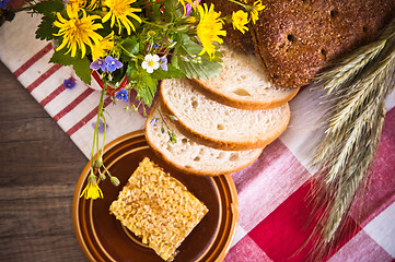 Image showing Still life with honeycombs, flowers and pot