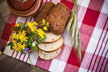 Image showing Still life with bread, flowers and pot