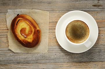 Image showing cup of espresso and fresh bun 