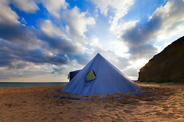 Image showing Conical tent on summer beach and blue sky with clouds