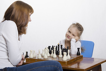 Image showing Mother explains daughter purpose of the chess pieces