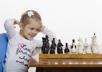 Image showing Girl playing chess in a good mood