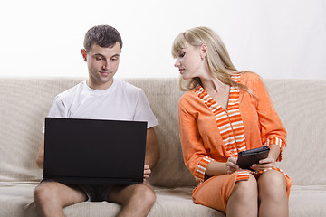 Image showing guy with laptop sitting on couch, girl into his