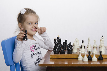 Image showing Girl toying playing chess