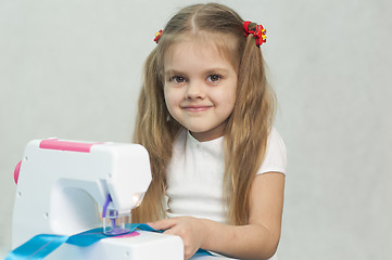 Image showing Girl sewing on the machine