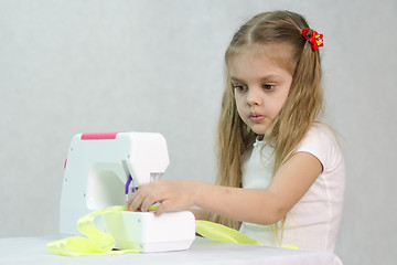 Image showing Girl sewing on the machine