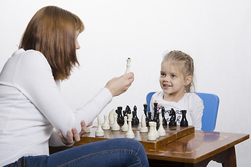 Image showing Mother explains daughter purpose of the chess pieces