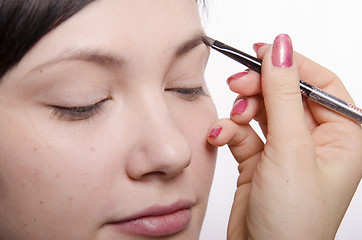 Image showing Makeup artist brings eyebrow pencil model