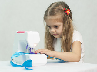 Image showing Girl sewing on the machine