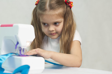 Image showing Girl sewing on the machine