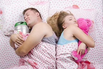 Image showing husband sleeps barrel of beer, wife with soft toy