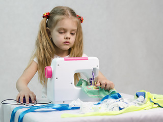 Image showing Girl sewing on the machine