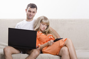 Image showing Guy and girl asleep, sitting on couch with laptop