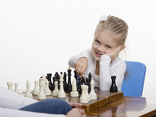 Image showing Girl playing chess in a good mood