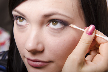 Image showing Makeup artist colors upper eyelids model