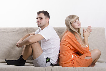 Image showing Couple sitting on couch with his back to each other