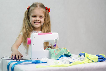 Image showing Girl sewing on the machine