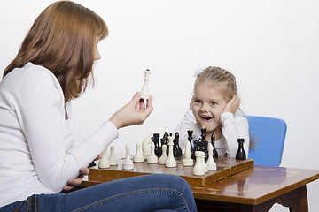 Image showing Mother explains daughter purpose of the chess pieces