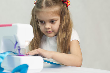 Image showing Girl sewing on the machine