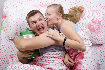 Image showing he with a barrel of beer, she tries to take away