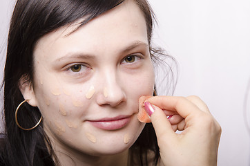 Image showing Makeup artist deals Foundation on the model's face