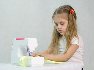 Image showing Girl sewing on the machine