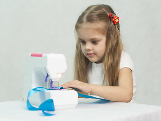 Image showing Girl sewing on the machine