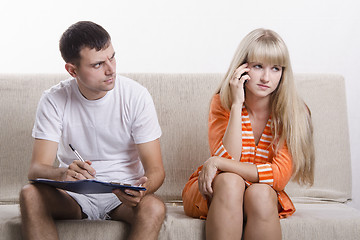 Image showing girl calls you on phone, sitting next to a guy and writes notes