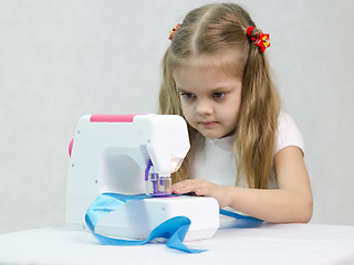 Image showing Girl sewing on the machine