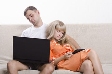 Image showing Guy and girl asleep, sitting on couch with laptop