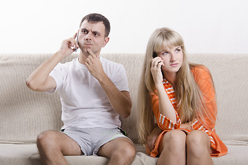 Image showing young couple phone sitting on couch