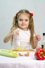 Image showing Girl playing in a cook churn whisk eggs glass bowl