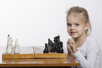 Image showing Four-year-old girl learns to play chess