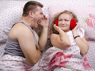 Image showing The guy is yelling at girl lying in bed