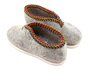 Image showing Two traditional grey felt slippers posed heel to toe