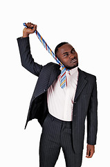 Image showing Black man pulling his tie.