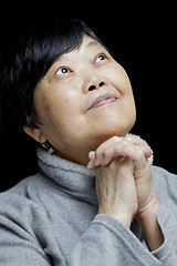 Image showing Asian woman praying and praising the Lord 