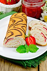 Image showing Roulade with jam and strawberries on a board