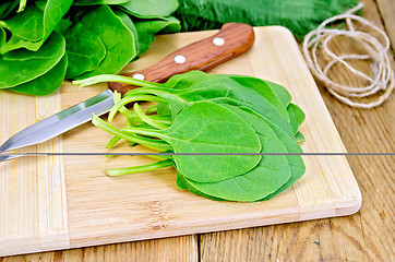 Image showing Spinach on the board with a knife