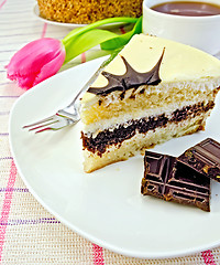 Image showing Cake with chocolate and pink tulips on the tablecloth