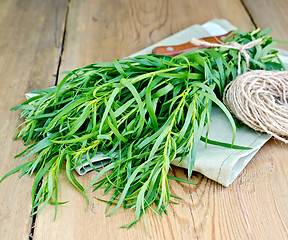 Image showing Tarragon with a knife and twine on the board