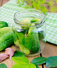 Image showing Cucumbers in a jar with leaves and napkin