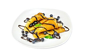 Image showing Pancakes with blueberries and chocolate in a plate