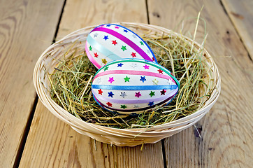 Image showing Easter eggs with ribbons and sequins in a basket