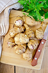 Image showing Jerusalem artichoke with a knife on board