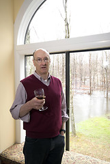 Image showing man in house with flooded backyard