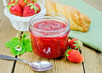 Image showing Jam of strawberry with a bun on the board